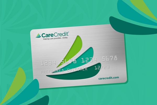 CareCredit payment card displayed on turquoise background with green leaf design elements.